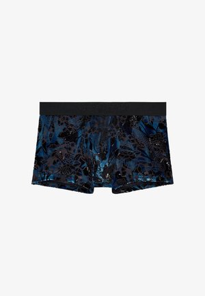 Musta-sinisillä kukkakuviolla varustetut bokserishortsit, joissa musta joustava vyötärönauha. Valmistettu pehmeästä, teksturoidusta kankaasta ja istuvalla mallilla.