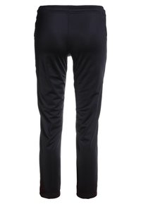 Puma LIGA TRAINING PANTS CORE  - Jogginghose - black/white