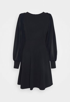 Black dress with fitted bodice, flared skirt, and sheer puff sleeves. Features a round neckline and smooth texture. No visible patterns.
