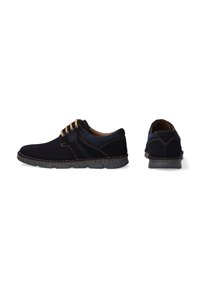 Navy blue suede lace-up shoes with beige stitching, textured accents, and rubber sole. Side view shows smooth shape; back view highlights stitching.