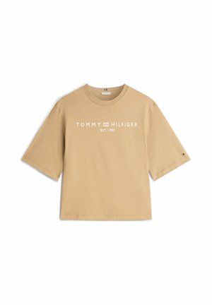T-shirt beige oversize in cotone, con maniche corte e scollo rotondo. Logo bianco "TOMMY HILFIGER EST. 1985" sul davanti.