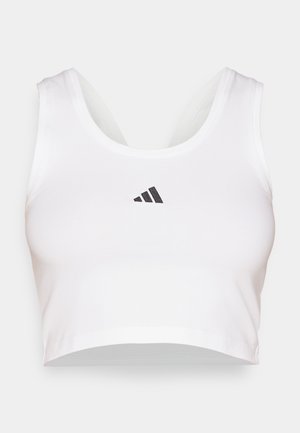 Hvitt crop top laget av mykt stoff, med rund hals og en svart Adidas-logo på forsiden. Glatt tekstur, ermeløs design.