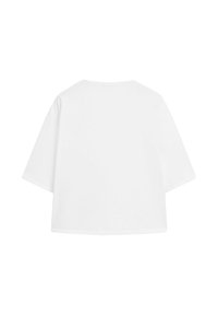 Plain white oversized short-sleeve t-shirt with a round neckline, displayed flat with the back facing forward on a white background.