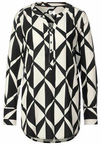 Blusa a maniche lunghe bianca e nera con un motivo geometrico, caratterizzata da un collo rotondo, una chiusura a bottoni e un orlo curvo. Tessuto morbido.