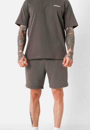 Gray cotton t-shirt with short sleeves and a round neckline, paired with matching gray shorts. Both have a relaxed fit and minimal design.