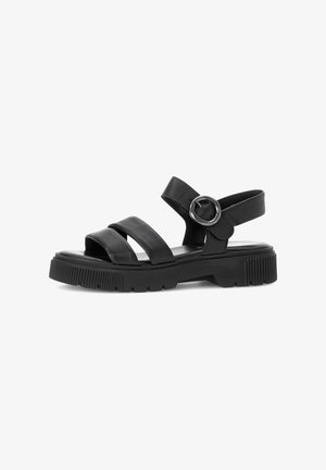 Black sandals featuring three wide straps and an adjustable ankle strap with a round metal buckle, on a textured rubber sole.
