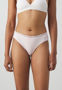 Light pink cotton panties with lace trim at the waistband, featuring a small satin bow at the center. Smooth texture, mid-rise design.