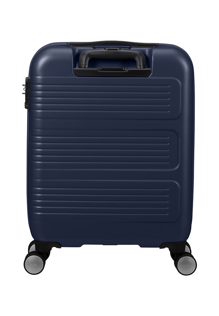 Valigia rigida blu navy con righe verticali, maniglia superiore nera e quattro ruote per la mobilità. Presenta una serratura combinata laterale.