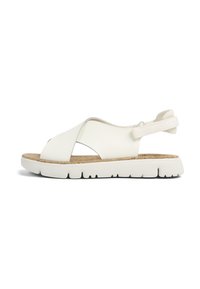 White leather sandal with an open toe design, cork footbed, elastic heel strap, and white rubber sole featuring a textured tread pattern.