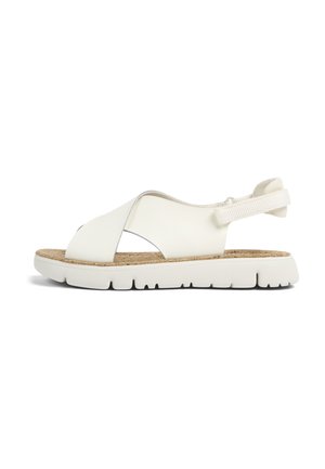 White leather sandal with an open toe design, cork footbed, elastic heel strap, and white rubber sole featuring a textured tread pattern.
