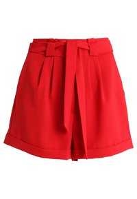 Red tailored shorts with a high waist, featuring a front tie detail, pleats, and rolled cuffs. Made of smooth, lightweight fabric.