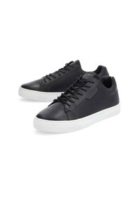 Baskets en cuir noir à finition lisse, dotées d'une semelle en caoutchouc blanche, d'un bout rond et de lacets. Design minimaliste avec un branding subtil.