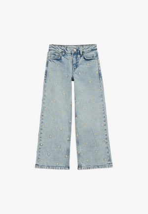 Vaaleansiniset leveälahkeiset farkut kukkaompeleilla. Klassinen viiden taskun malli ja hienovaraisesti rispaantunut lahkeenhelma.