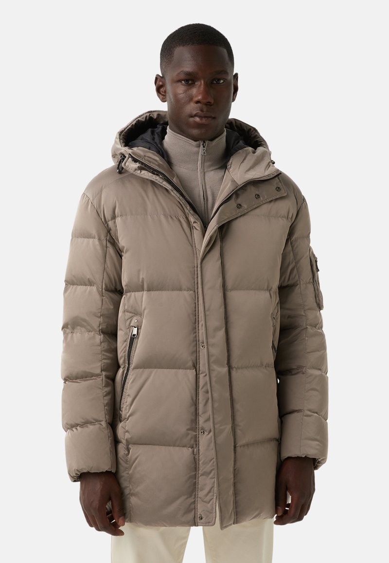 Puffer jacket in muted beige with a quilted design, hood, and two zippered side pockets. Features a high collar and elastic cuffs.