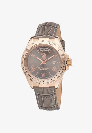 Brown leather strap with crocodile texture, gold-tone metal case, gray dial with Roman numerals, day/date window, and logo accent.