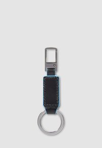 Keyring with black stitched leather strap and silver metal clip and ring on light gray background.