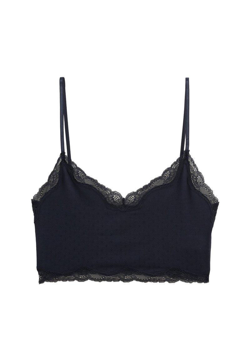 Bralette en dentelle marine foncé avec des bretelles réglables fines et une texture à pois sur le tissu, avec des bords festonnés le long de l'encolure.