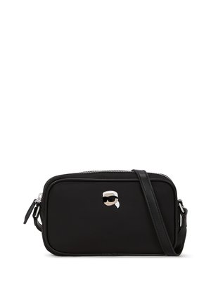 Black crossbody bag made of textured material with a zip closure, featuring a monochromatic cartoon character logo on the front.