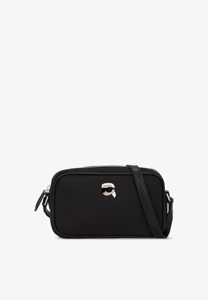 Black crossbody bag made of textured material with a zip closure, featuring a monochromatic cartoon character logo on the front.