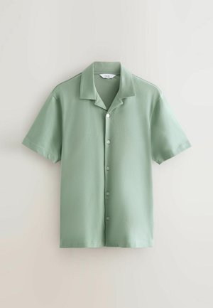 Short-sleeve, button-up shirt in soft green fabric. Features a collar, six buttons down the front, and a straight hem. Smooth texture.