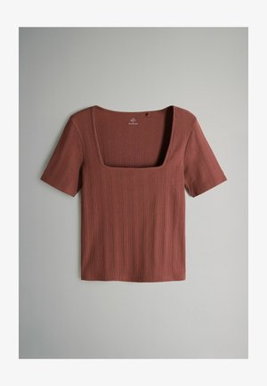 Rust-colored short-sleeve top with a square neckline, ribbed texture, and a straight hem. Features subtle horizontal lines throughout.