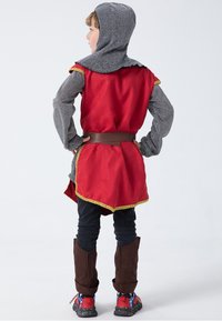 Red tunic with gold trim, gray hooded shirt, brown belt, black pants, and brown boots with red accents. Kid shown from the back.