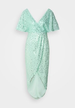 Puku mint vihreä V-pääntiellä ja liehuvilla hihoilla, koristeltu hopeisilla kimalteilla. Sisältää draperoidun siluetin ja sivuhalkion.