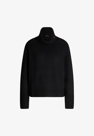 Pull en col roulé noir avec des poignets et un ourlet côtelés, présentant une coupe ample et une texture en maille lisse. Détail d'accent subtil près du col.