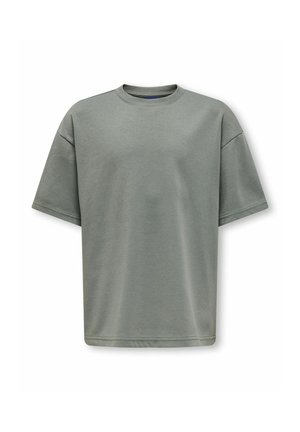 T-shirt en coton uni vert olive oversize à manches courtes, col rond et coutures visibles aux manches et à l'ourlet.