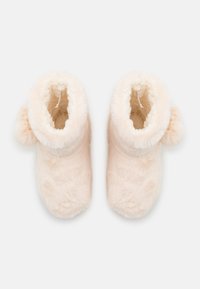 Soft, fluffy pink slippers with a high collar and round pom-pom accent. Inside lined with plush material for comfort. Smooth, textured surface.