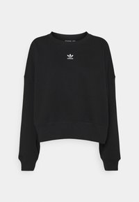 Svart sweatshirt med en kortad design, med långa ärmar och rundad halsringning. Visar en vit Adidas-logga på bröstet. Mjuk textur.