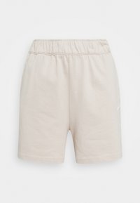 Beiga bomullsshorts med elastisk midja och en liten logotypdesign på vänster sida. Mjuk textur och mittlängd på låret.