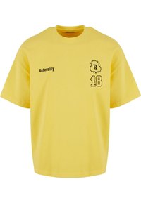 Yellow cotton T-shirt with a round neck, short sleeves, featuring black printed text "Reternity" and the numbers "18" with a decorative accent.