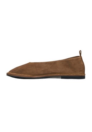 Brown suede flat shoe with a rounded toe, subtle stitching along the edge, and a small pull tab at the back; minimalist design.