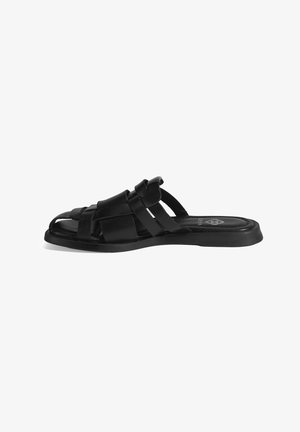 Black slide sandal featuring woven straps, open toe design, and a flat sole. Made from textured material with a sleek finish.