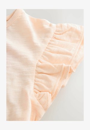 Šviesiai persiko spalvos trumpomis rankovėmis marškiniai, pagaminti iš minkštos, tekstūruotos medžiagos su raukiniais rankovėse. Paprastas, laisvalaikio dizainas.