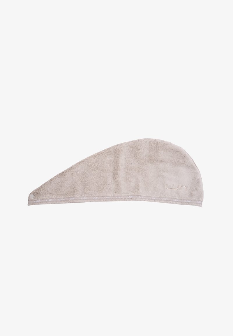Toalla de microfibra beige para el cabello, forma de media luna, textura suave, cuenta con un lazo y una etiqueta LUI en el borde. Ideal para secar el cabello.