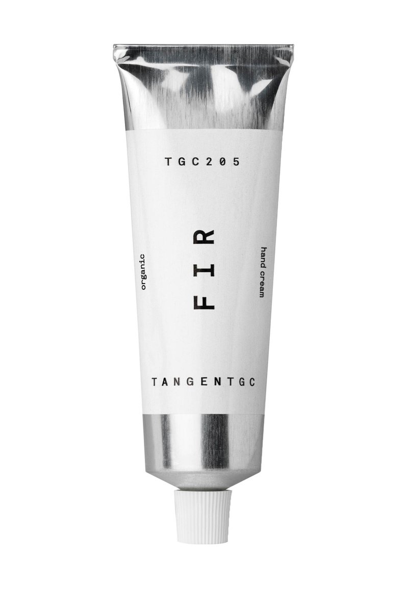 Aluminiumtube von FIR Handcreme, weiße Etikette mit schwarzem Text, mit runder Kappe, organische Formel, schlanke zylindrische Form.