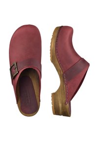 Red leather clogs with a curved toe, a brown buckle on the strap, and a wooden sole featuring a textured pattern and stitching details.