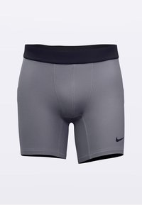 Grå treningsshorts med svart midjebånd, med en tettsittende passform og glatt tekstur. Har en liten svart Nike-logo på siden.