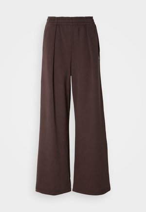 Braune weite Hosen mit elastischem Bund und seitlichen Taschen. Hergestellt aus weichem Stoff mit glatter Textur und schlichtem, sauberem Design.