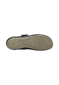 Semelle de chaussure en cuir noir avec un motif floral texturé et une forme courbée. La semelle extérieure est d'un beige clair avec un design surélevé et un détail de marque.