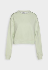 Felpa cropped verde chiaro con maniche lunghe, colletto rotondo e dettagli floreali lungo le spalle. Materiale morbido in misto cotone.