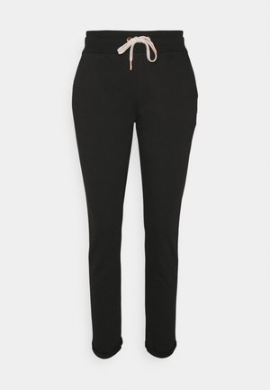 Zwarte sweatpants met een trekkoord in de taille, met een zachte textuur, taps toelopende pijpen en omgekrulde manchetten bij de enkels.