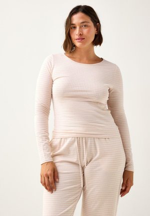 Maglietta a maniche lunghe rosa chiaro con motivo a griglia e pantaloni da pigiama coordinati. Realizzata in tessuto morbido, presenta una vestibilità comoda e un elastico con coulisse in vita.