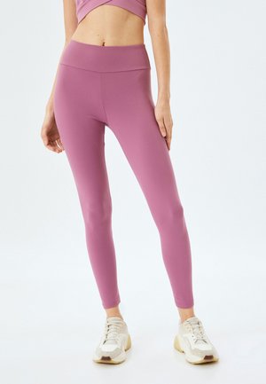 Leggings roses avec une taille haute, fabriqués à partir d'un tissu lisse et extensible. Ils sont ajustés et se resserrent au niveau des chevilles.