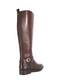 Brown leather knee-high boot with a smooth finish, rounded toe, and a decorative buckle strap on the ankle. Metal accents at the heel.