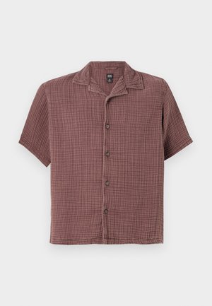 Short-sleeve, button-up shirt in a textured mauve fabric with a grid pattern. Features a straight collar and six front buttons.