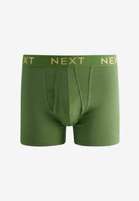 Boxers en coton vert avec un logo doré "NEXT" sur la ceinture, présentant une coupe ajustée et une texture lisse.
