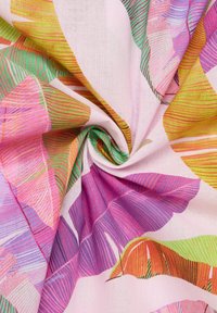 Colorful fabric with a floral pattern, featuring pink, orange, green, and purple leaves on a light pink background, with a smooth texture.